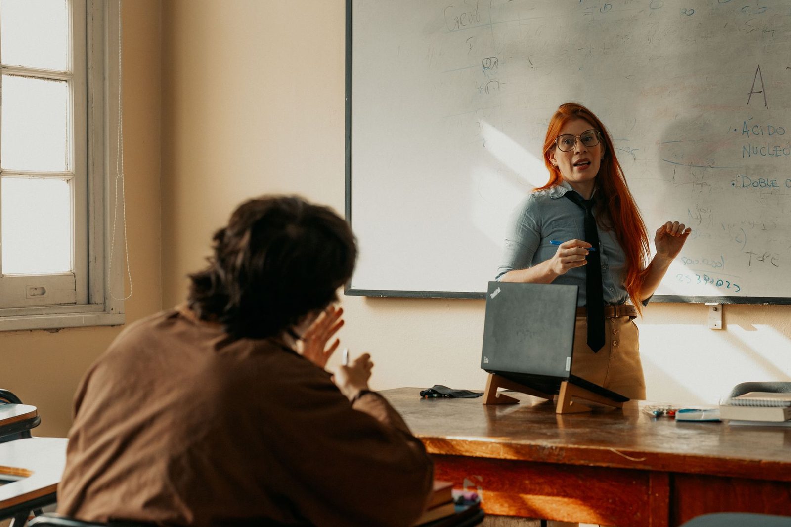 AP teacher leading a college-level course in a high school classroom