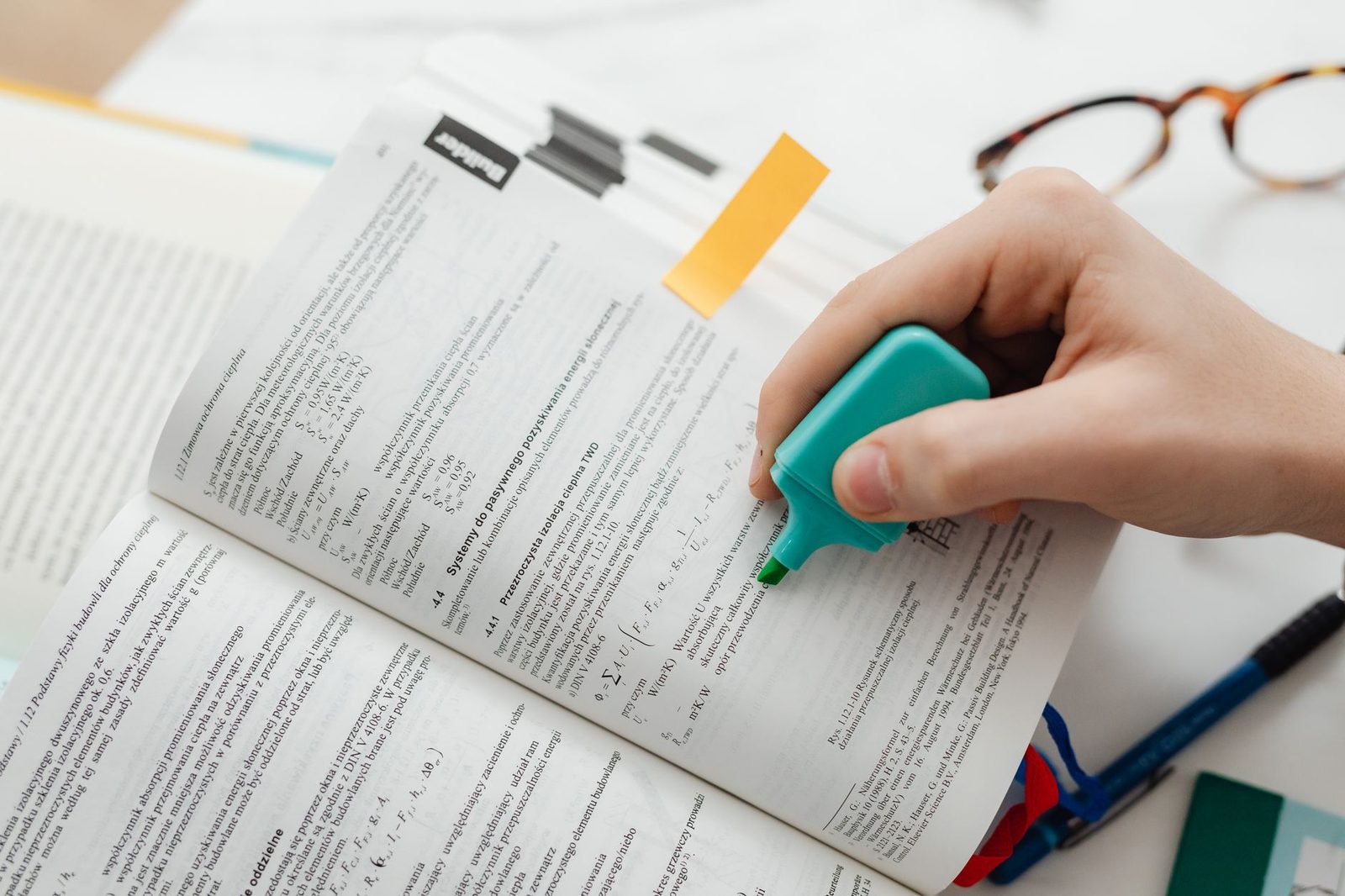 Student reviewing a prep book with notes