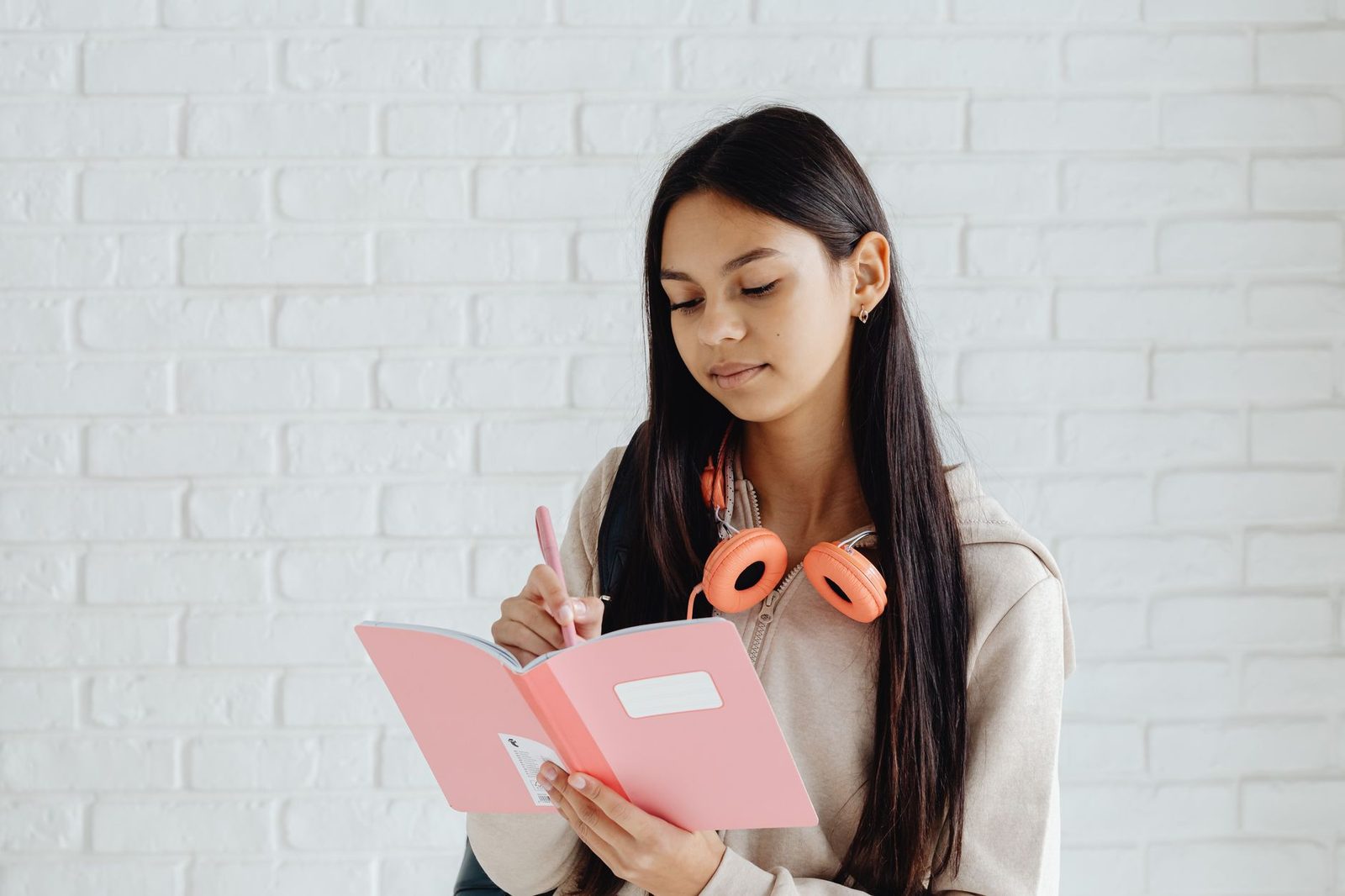 Student writing in a journal while brainstorming ideas