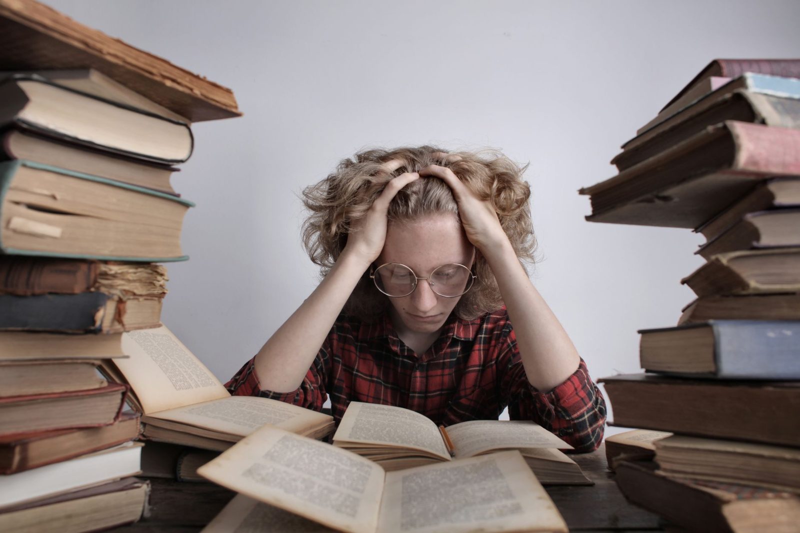 Student reading books at a desk