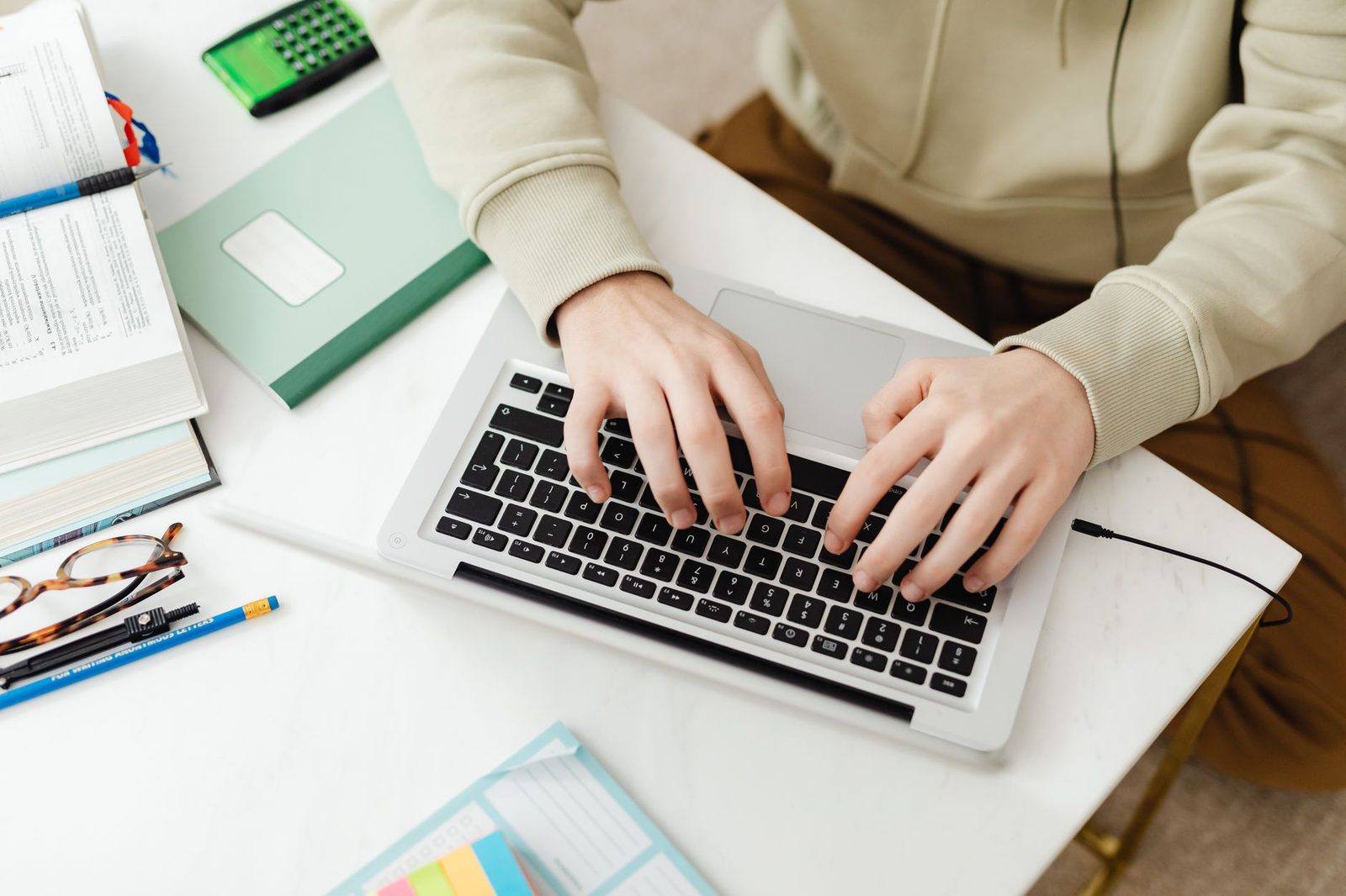 Student writing college essay on laptop