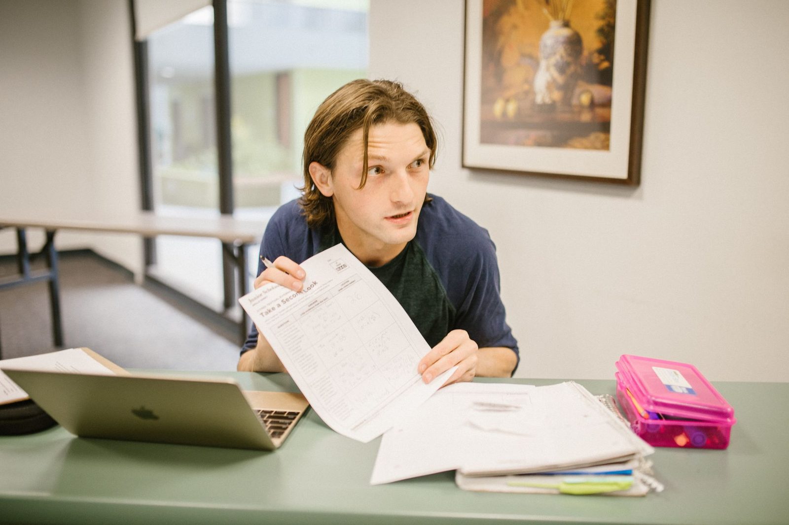 Student reviewing college list and application materials