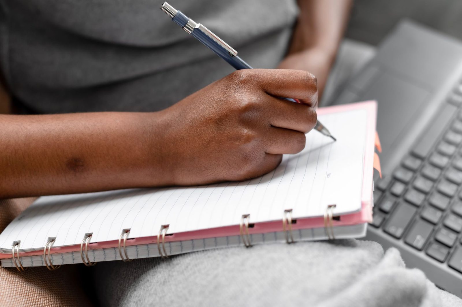 Student writing notes during a college information session