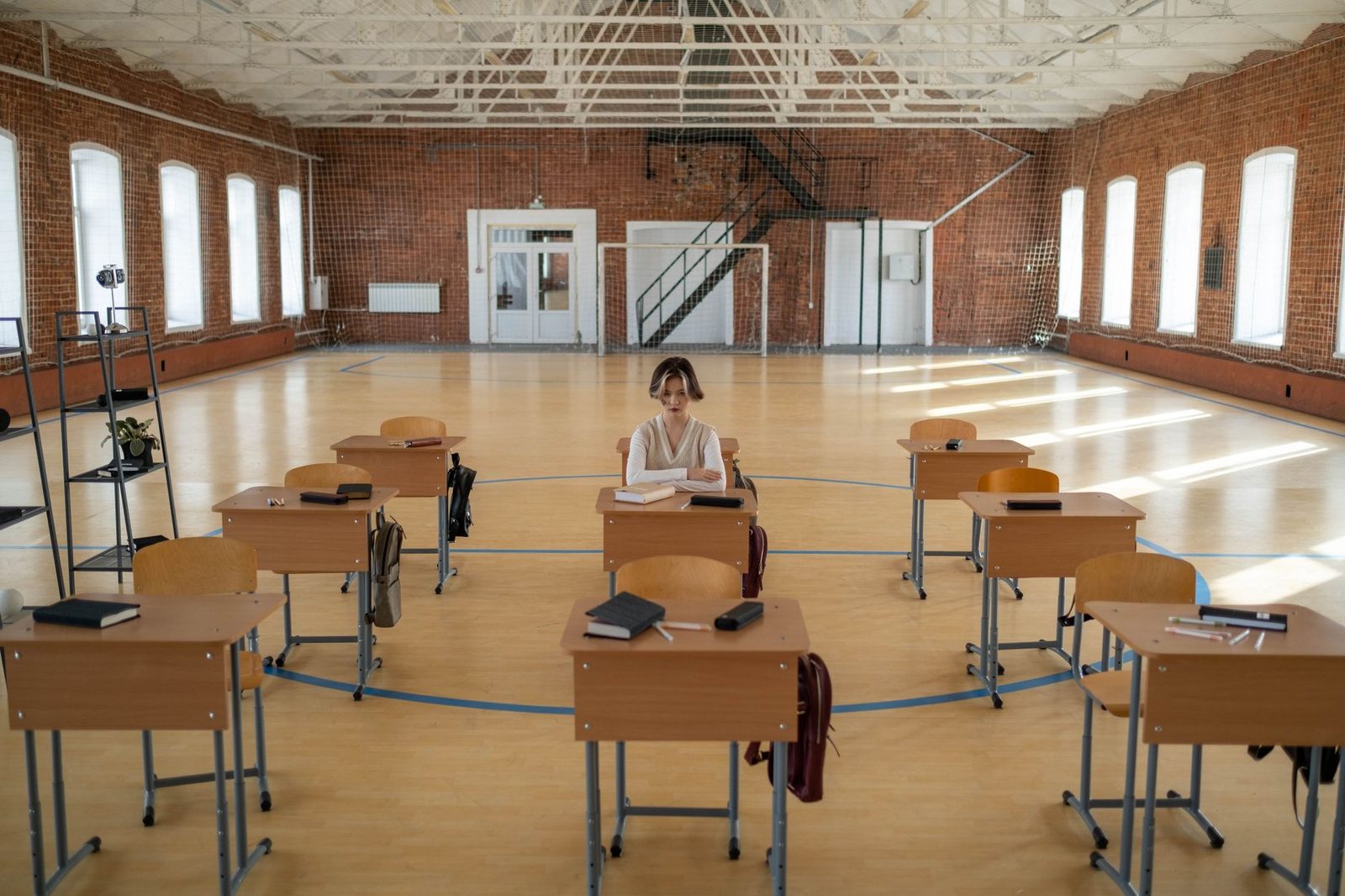Student self-studying at a desk with textbooks and notes