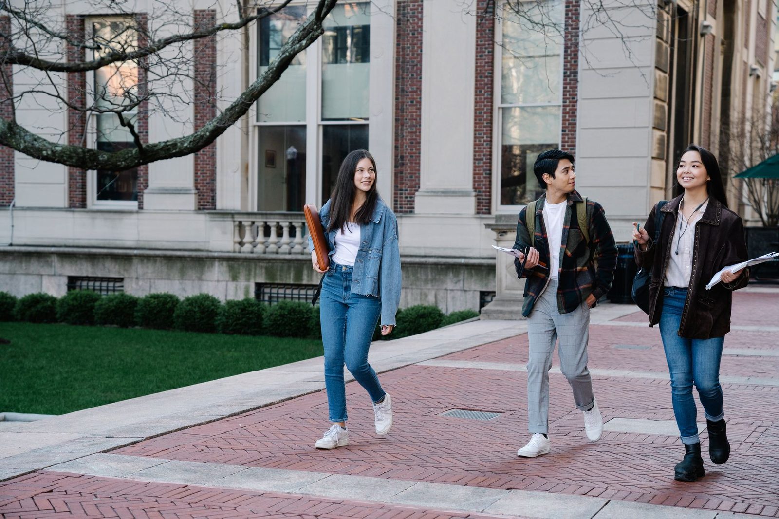 Students walking across a busy urban university campus
