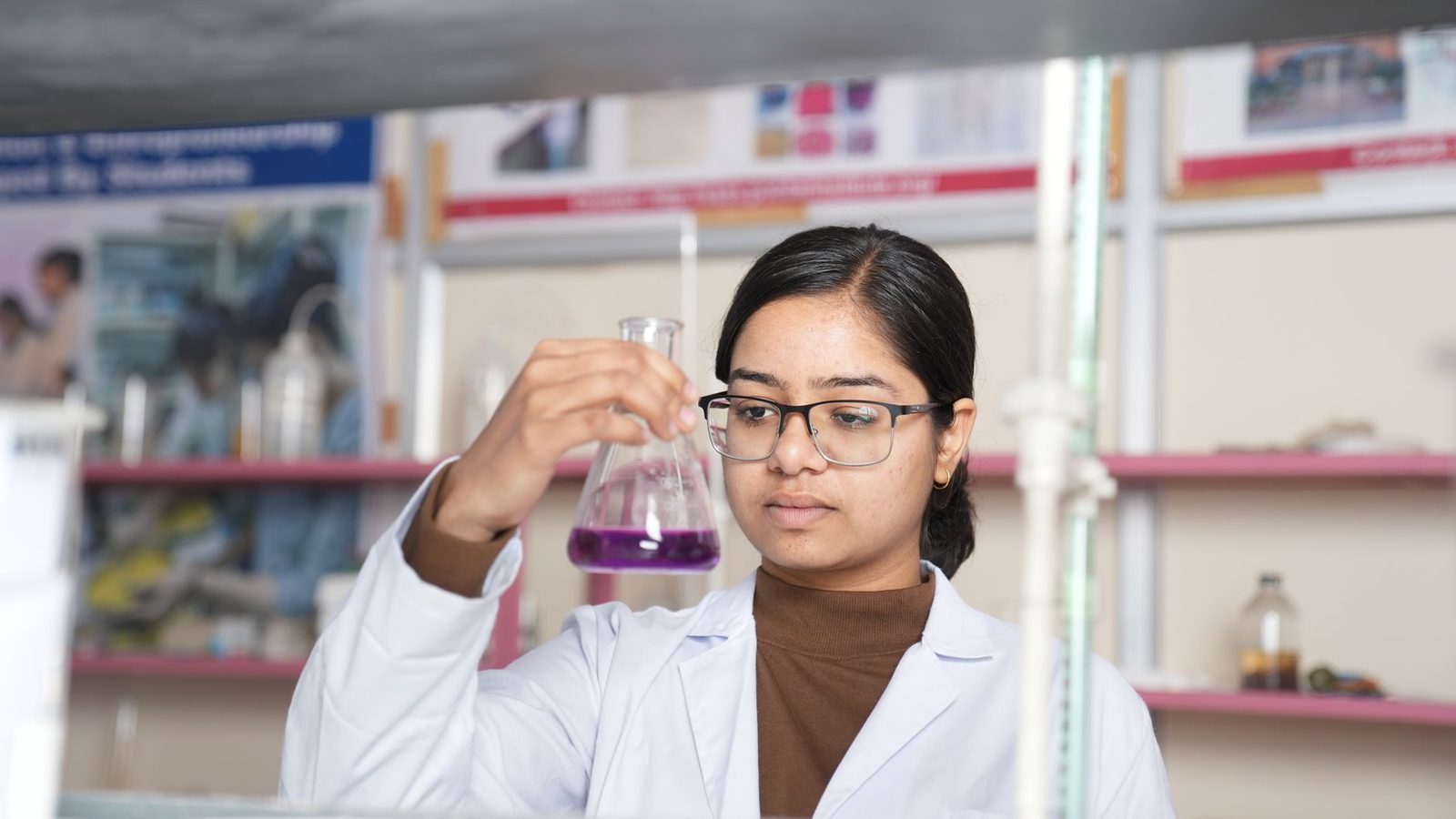 High school student conducting independent research in a laboratory setting