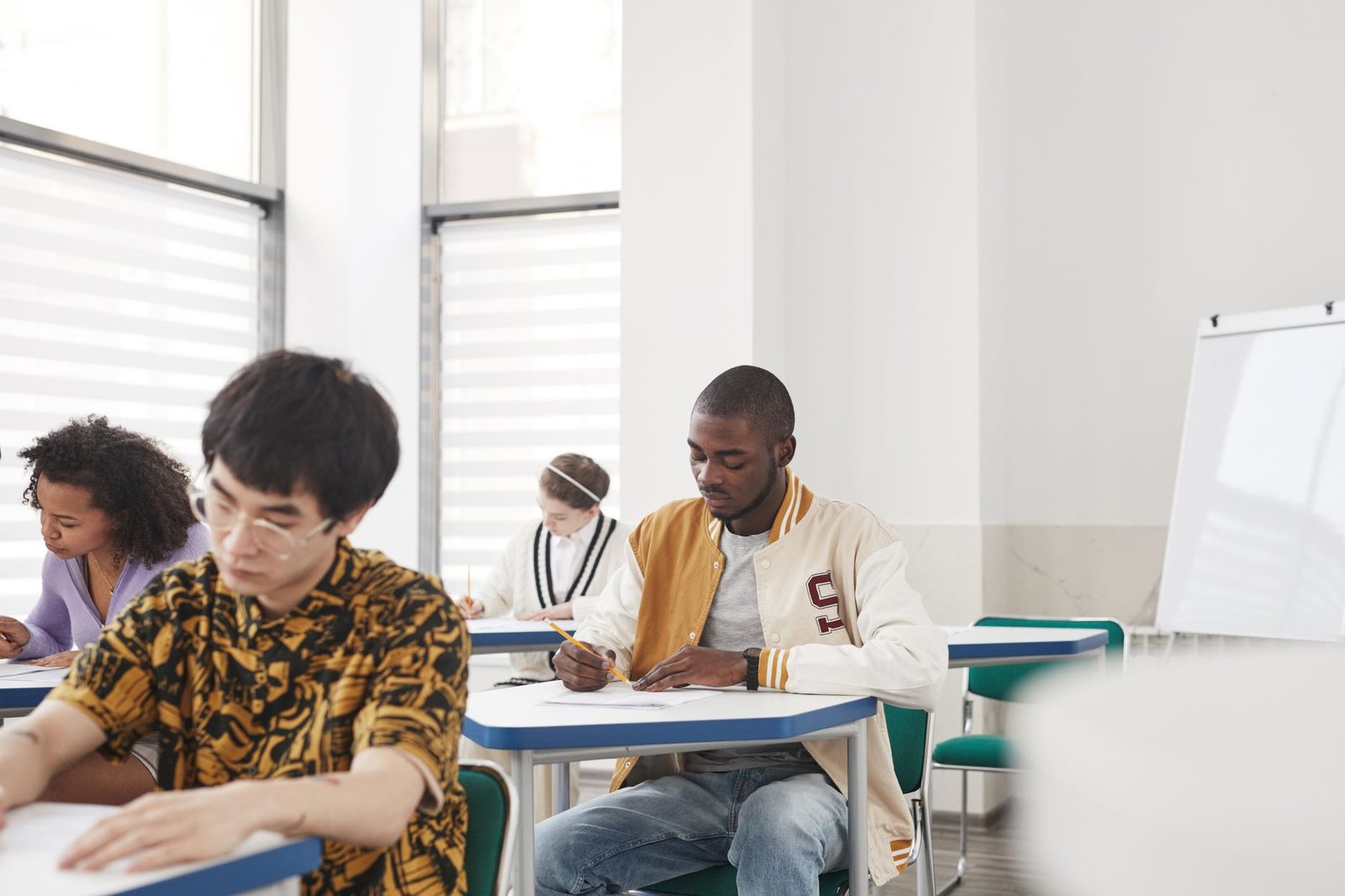 A student reviewing college application materials at a desk