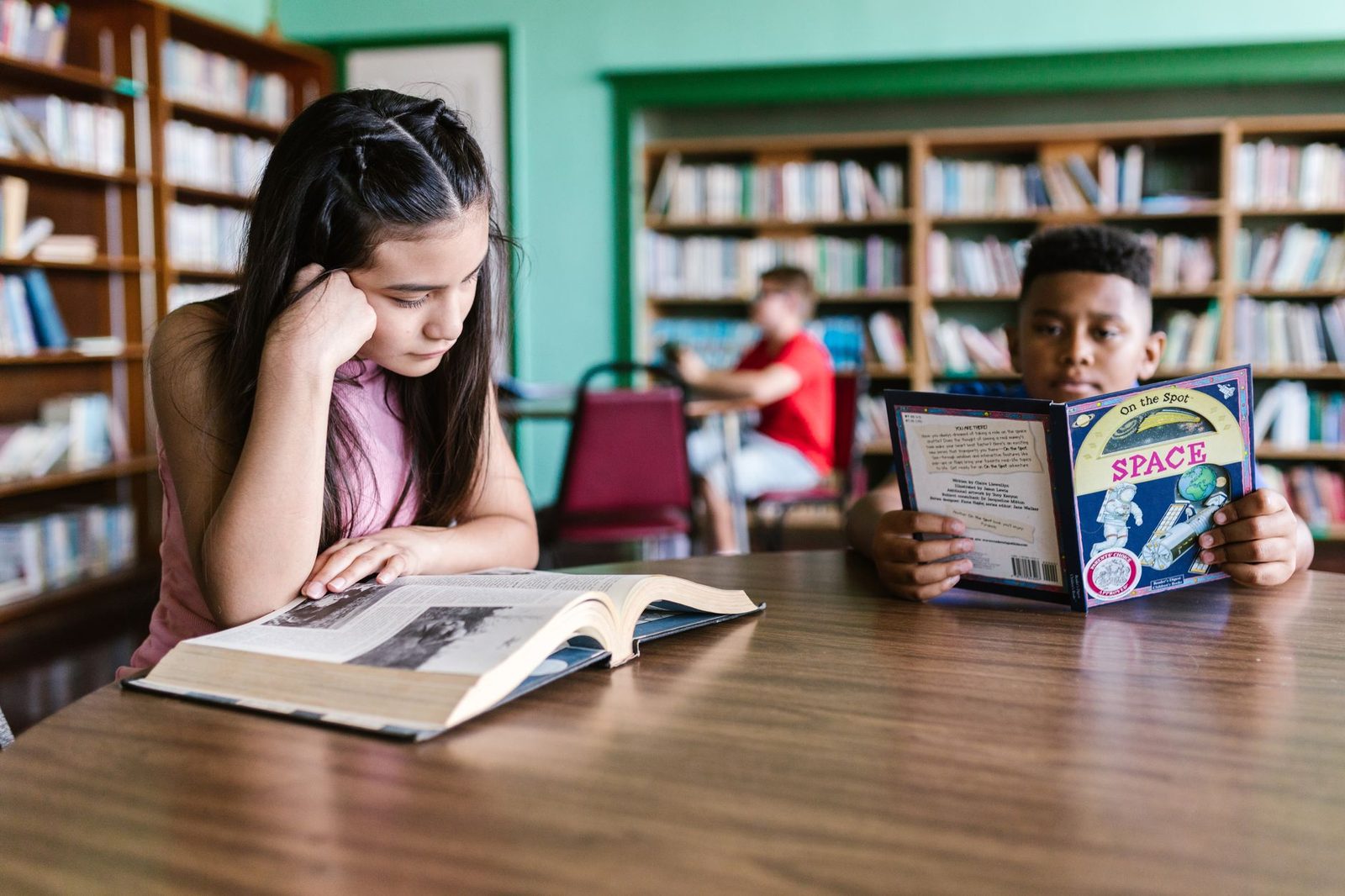 Student looking puzzled while reading a passage at a desk