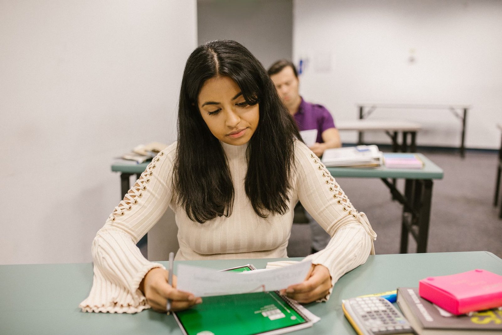 Student reviewing a written essay draft