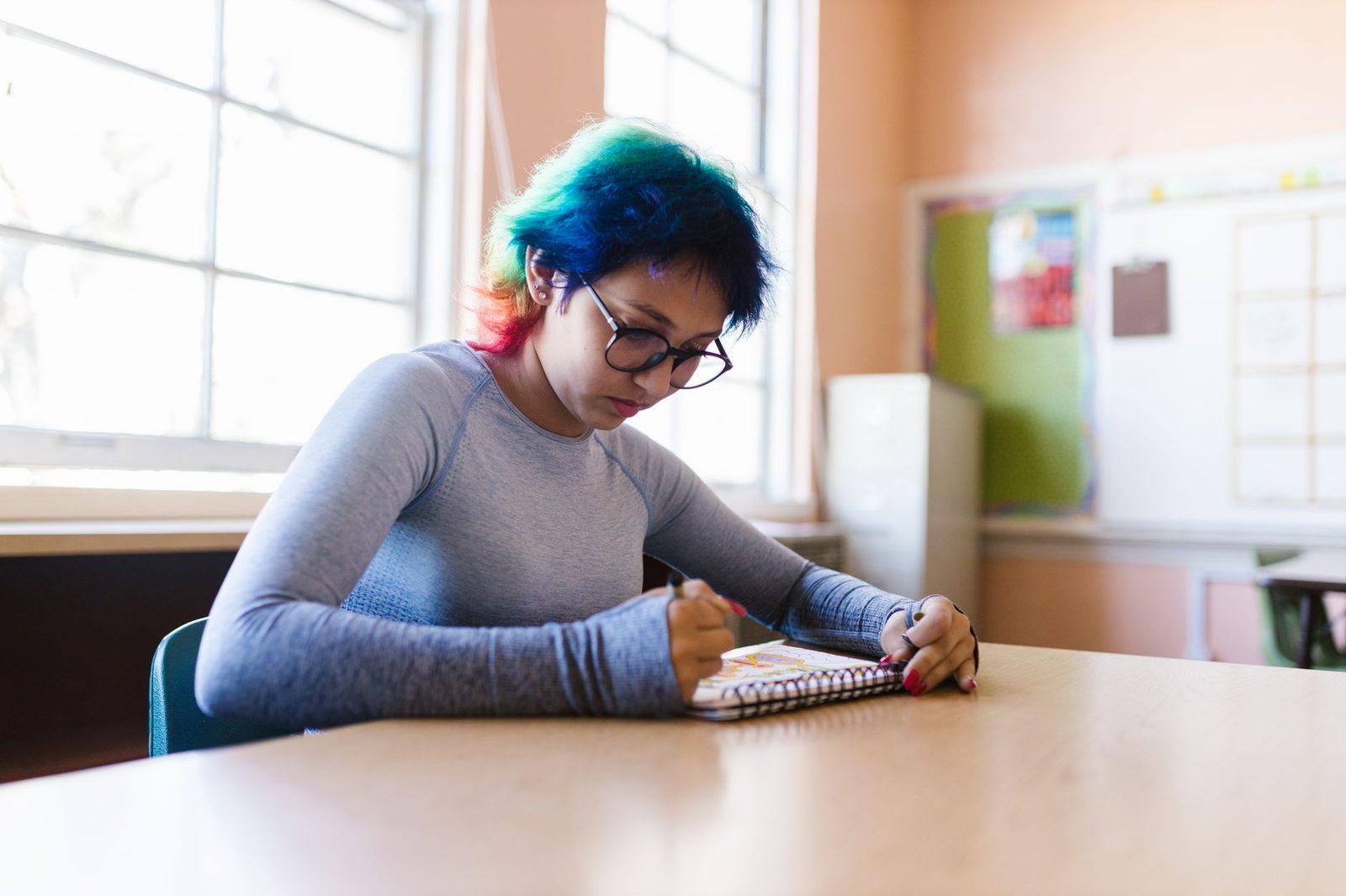 Ninth grade student studying and planning coursework in a classroom setting