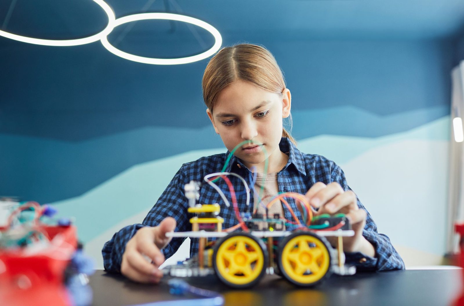 Student examining an engineering prototype in a workshop