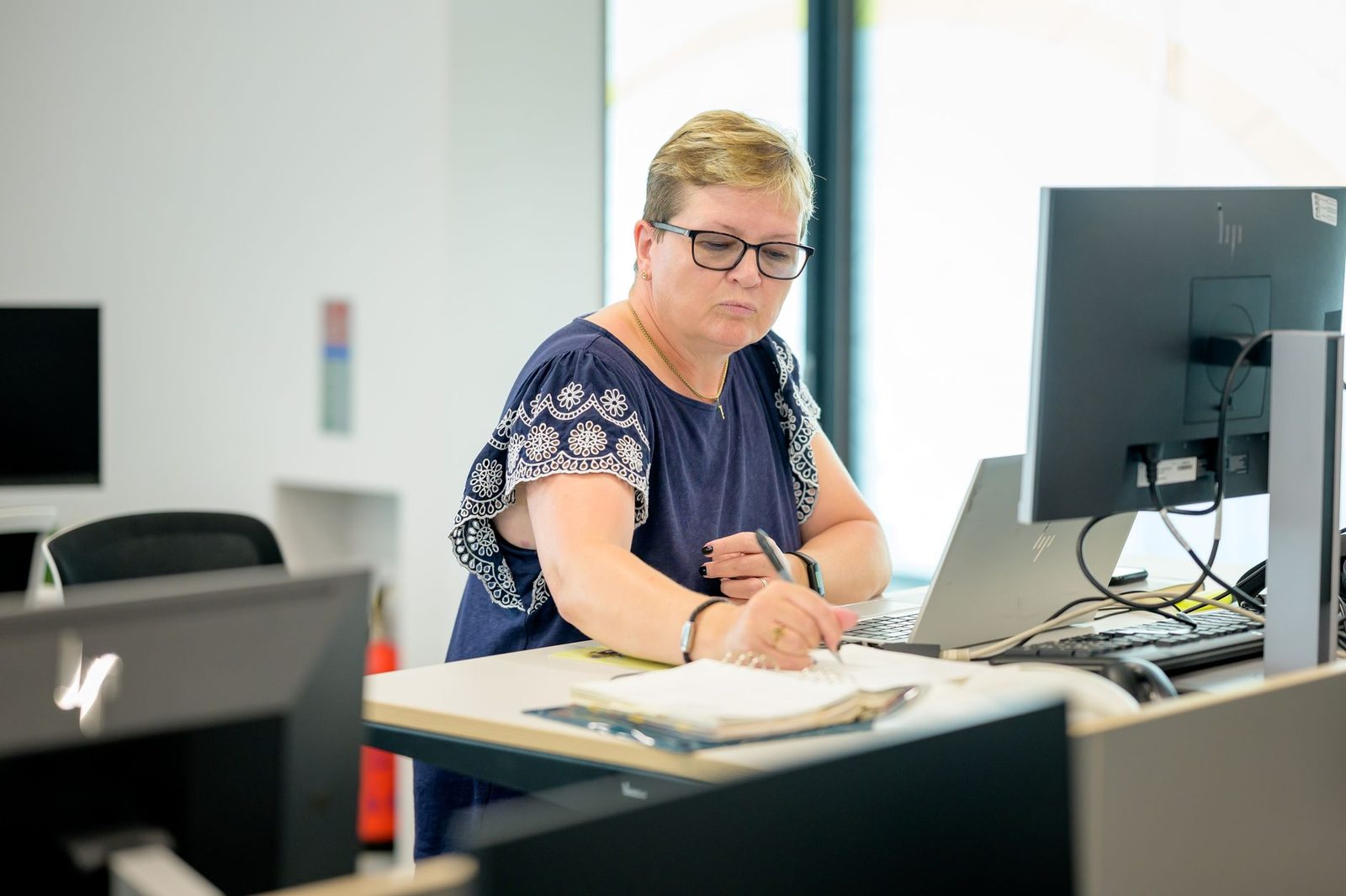 Student organizing documents at a desk for a school accommodation request