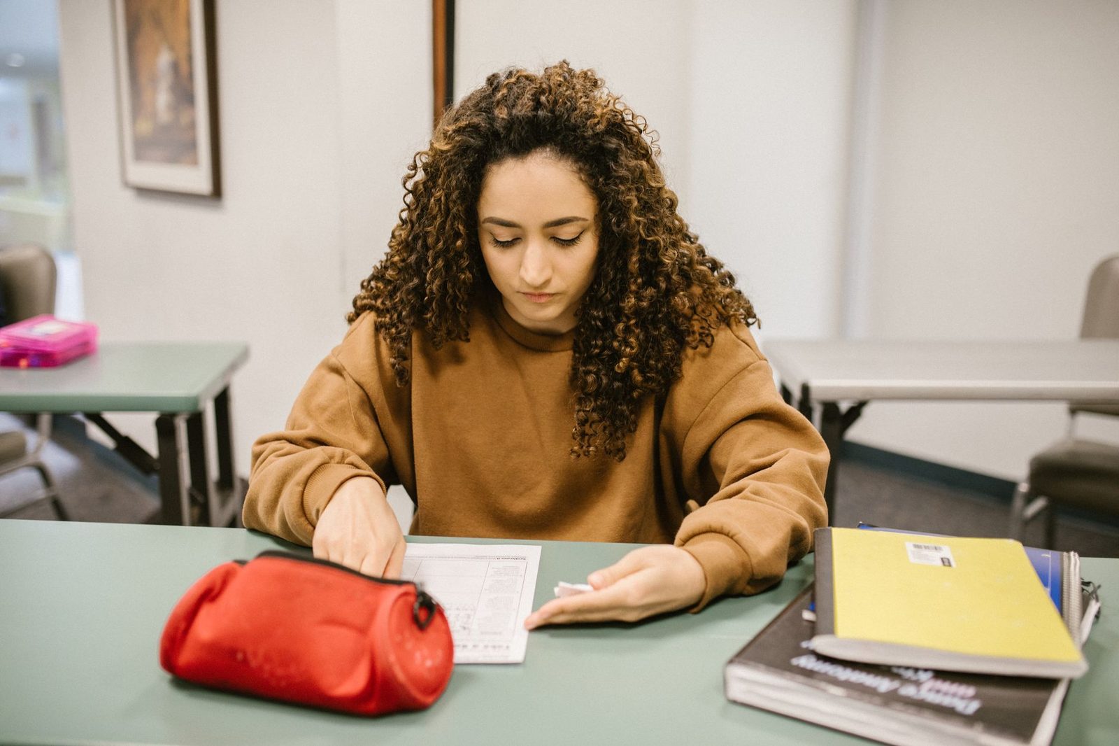 Student reviewing practice exam materials at a desk