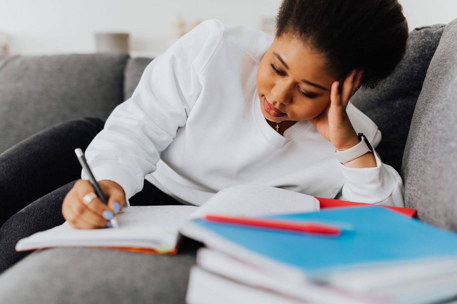 Student writing college application essays on a laptop