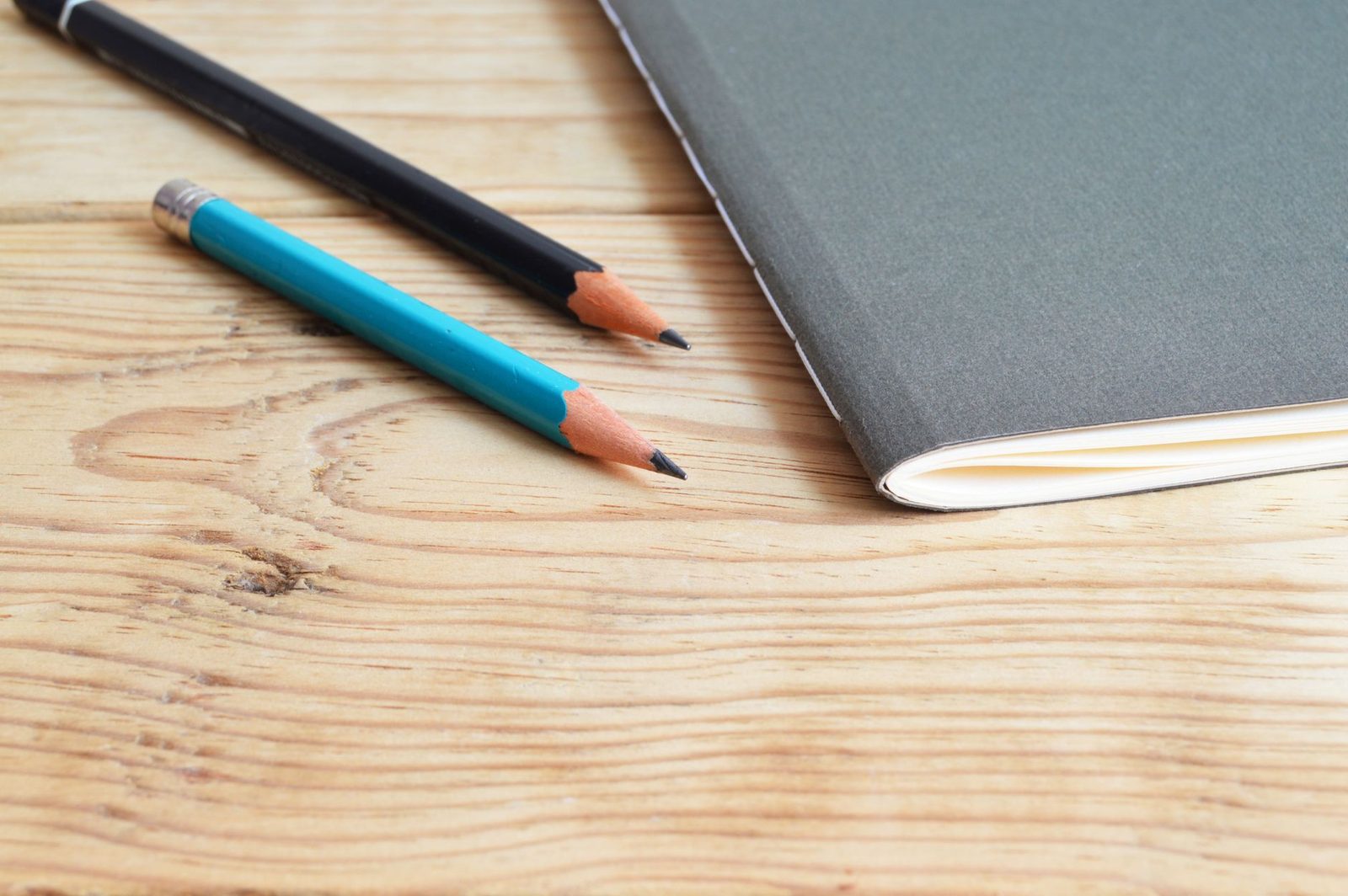 Student writing in a notebook at a desk