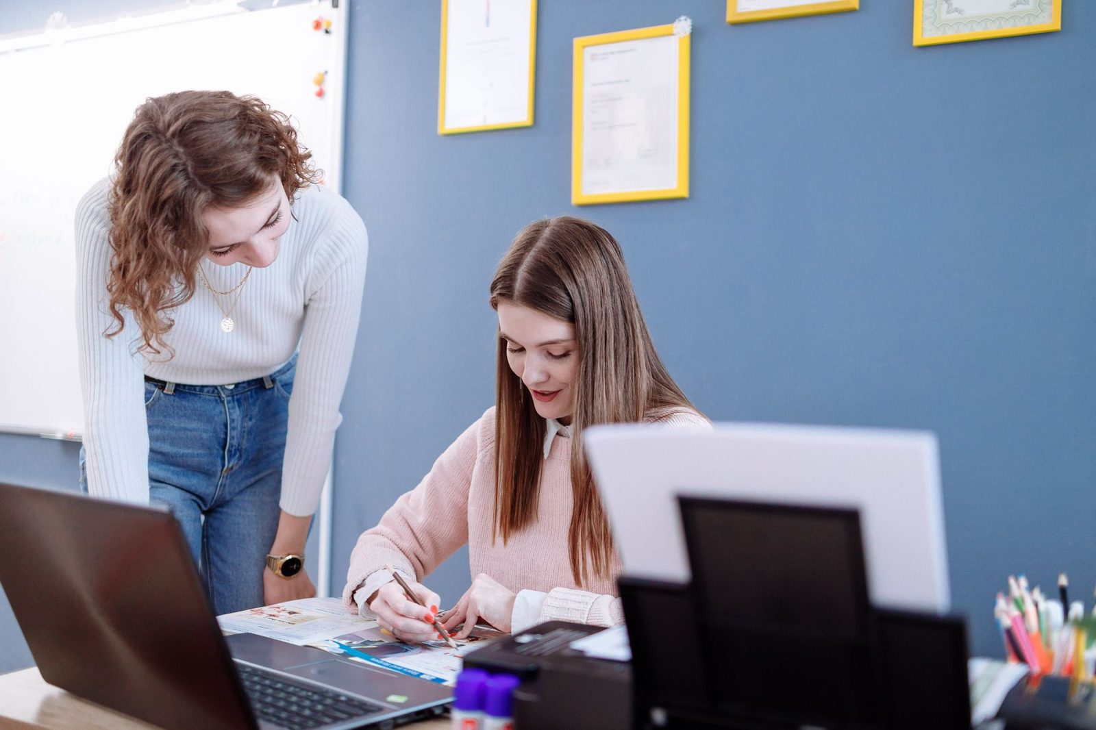 Tutor and student reviewing practice test results together at a table